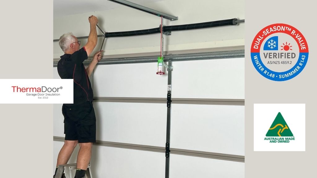 Peter Hinton installing ThermaDoor® Premium garage door insulation and perimeter seals, performing professional spring adjustment as part of a compliant AS 3999 and AS/NZS 4505 installation. Australian-made, dual-season R-value verified insulation panels (R1.43 winter / R1.39 summer).