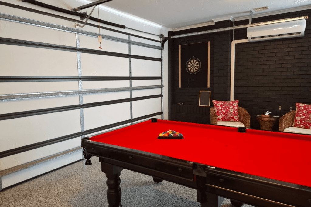 Insulated garage used as a recreation room with pool table