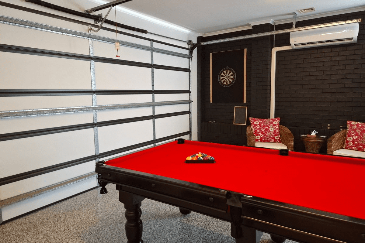 Insulated garage used as a recreation room with pool table