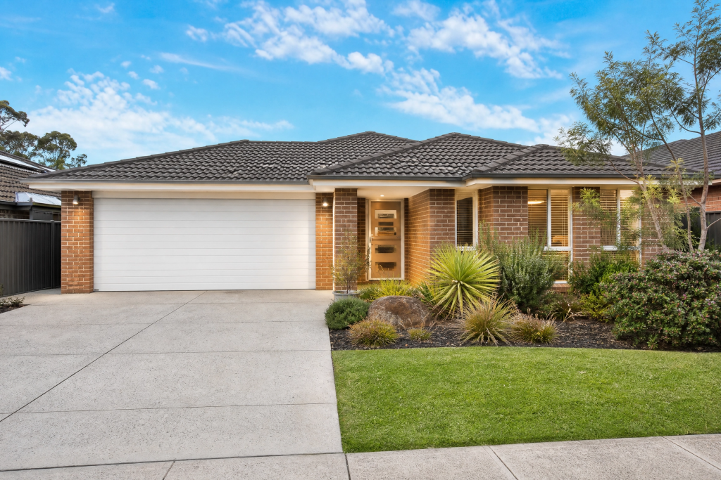 Well-presented Australian brick home with white sectional garage door — ThermaDoor garage door insulation for property sale and rental