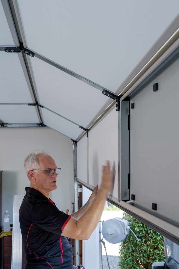 ThermaDoor foam packer spacer system creating air gap between insulation panel and garage door