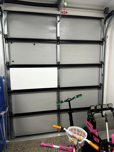 ThermaDoor garage door insulation mid-installation — one panel insulated, Melbourne