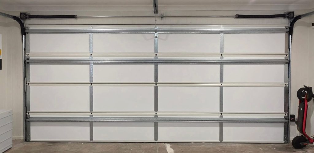 ThermaDoor retrofit garage door insulation installed on an existing sectional garage door