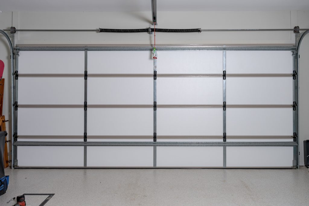 Insulated sectional garage door with ThermaDoor retrofit panels fitted